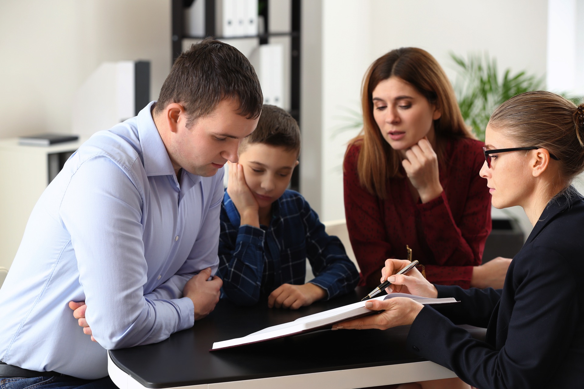 Divorced parents with their son visiting lawyer. Concept of child support Rivington Solicitors