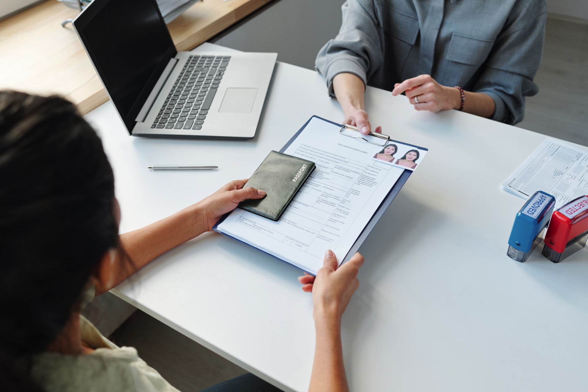 Woman Applying For Visa At Table Rivington Solicitors